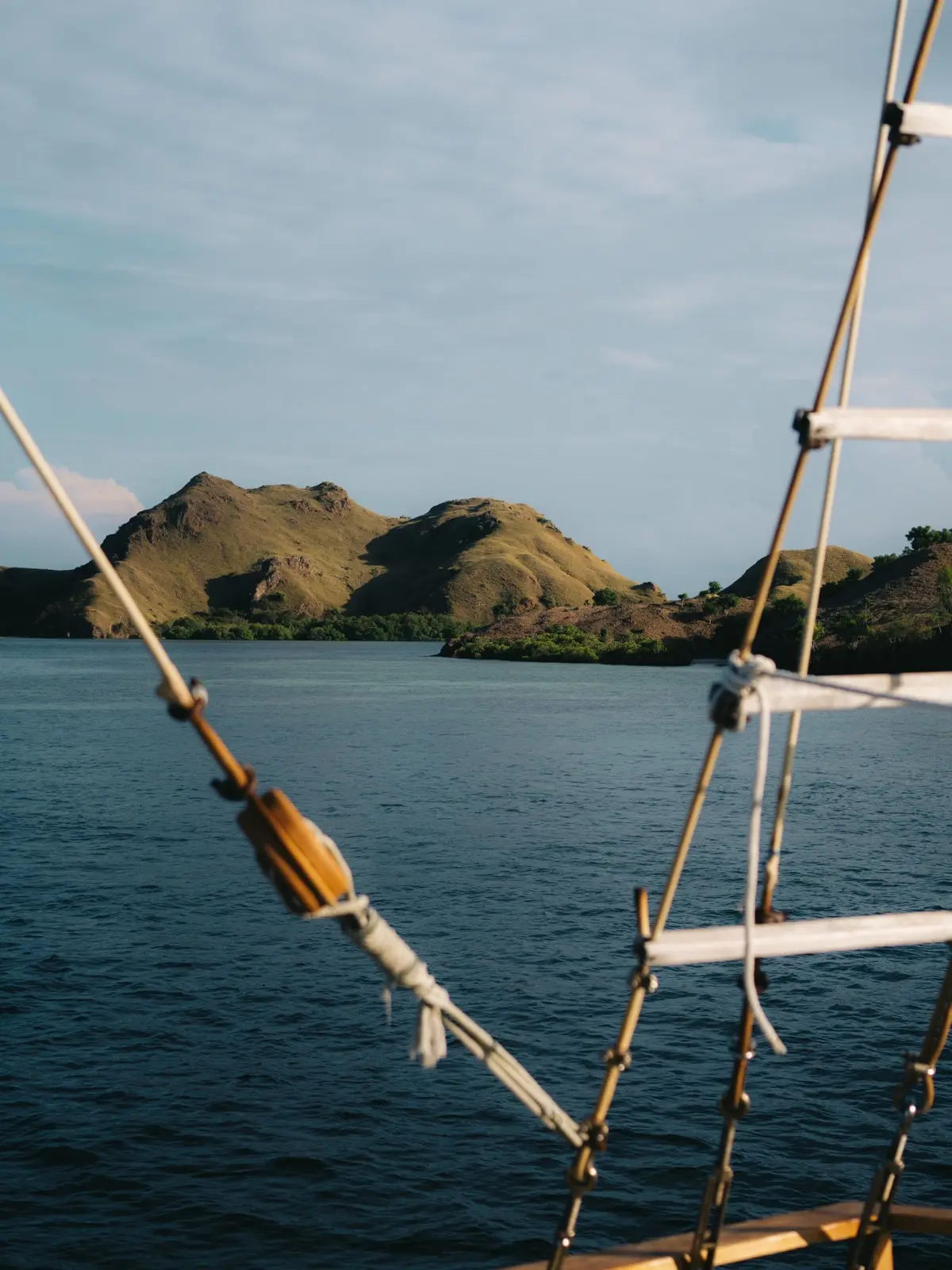 The view from a phinisi's rigging toward the hills of Komodo National Park